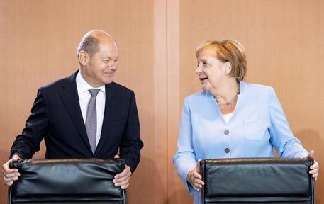 epa07772529 German Minister of Finance Olaf Scholz (L) and German Chancellor Angela Merkel attend a cabinet meeting at the German Chancellery in Berlin, Germany, 14 August 2019.  EPA/HAYOUNG JEON