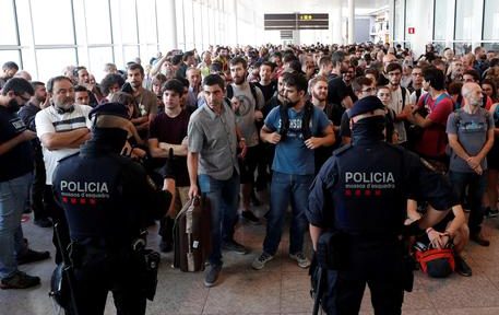epa07920055 Two Catalan regional policemen control the access to the Terminal 1 at Barcelona-El Prat international airport as members of the group called 'Tsunami Democratic' (Democratic Tsunami) called for 'shutting-down' the airport to protest against the sentence ruled by Supreme Court on 'proces' trial', in Barcelona, Catalonia, 14 October 2019. Demonstrators are blocking some roads in Catalan capital against the court's decision. Spanish Supreme Court condemned Oriol Junqueras to 13 years in jail for sedition, Carme Forcadell to 11 years and half for sedition; Jordi Cuixart and Jordi Sanchez were sentenced to 9 years and half for sedition; former regional Minister Jordi Turull, Raul Romeva and Dolors Bassa were sentenced to 12 years in jail for sedition and missapropriation, and Joaquin Forn and Josep Rull were condenmend 10 years an half for sedition. The three other defendants were absolved.  EPA/Alejandro Garcia