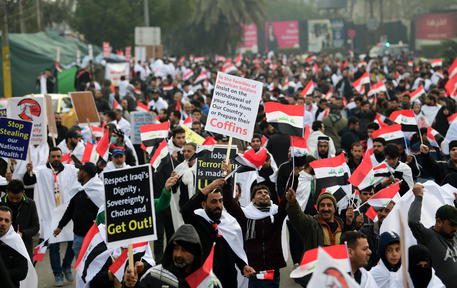 epa08158992 Supporters of Iraqi Shiite cleric Muqtada al-Sadr chant slogans and carry banners during a demonstration in central Baghdad, Iraq, 24 January 2020. Thousands of Muqtada al-Sadr followers and supporters of Iran-backed Shiite armed groups participated in a demonstration, calling for the US to end its military presence in Iraq, since the Iraqi Parliament approved a measure calling for United States troops to leave. The protest was called by Iraqi Shia cleric Muqtada al-Sadr.  EPA/AHMED JALIL