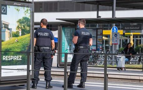 German police officers stand on a platform at a tram station in Kehl, on June 15, 2020, on the reopening day of the borders between France and Germany, closed as part of measures taken to stop the spread of the COVID-19 pandemic caused by the novel coronavirus. (Photo by PATRICK HERTZOG / AFP)