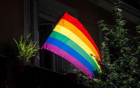 epa08511670 A rainbow flag is seen at the window of a flat in Chueca, known as the 'gay neighborhood', in Madrid, Spain, 27 June 2020.  EPA/Luca Piergiovanni